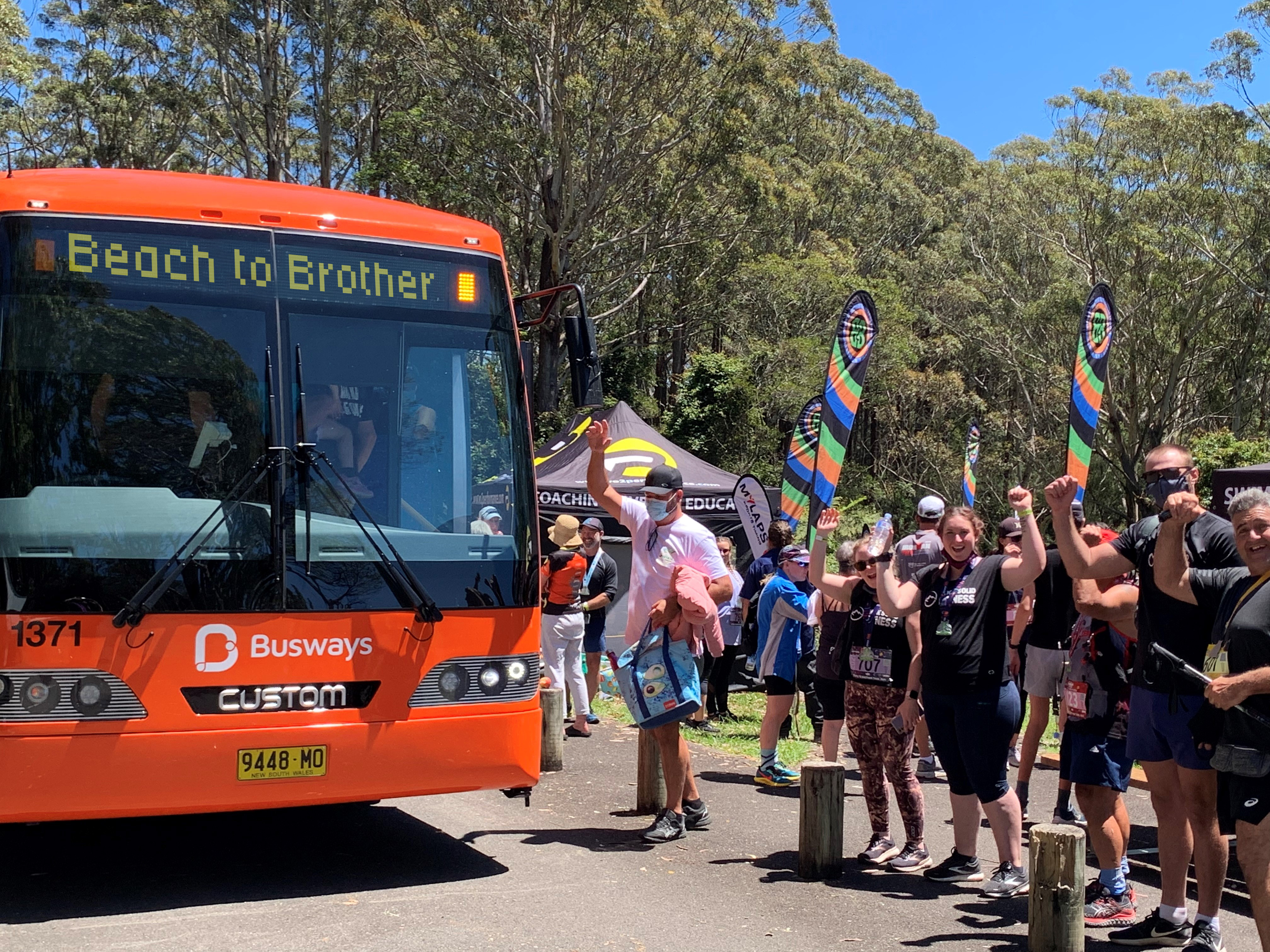 Busways shuttle bus Beach to Brother event participants getting on Busways shuttle bus