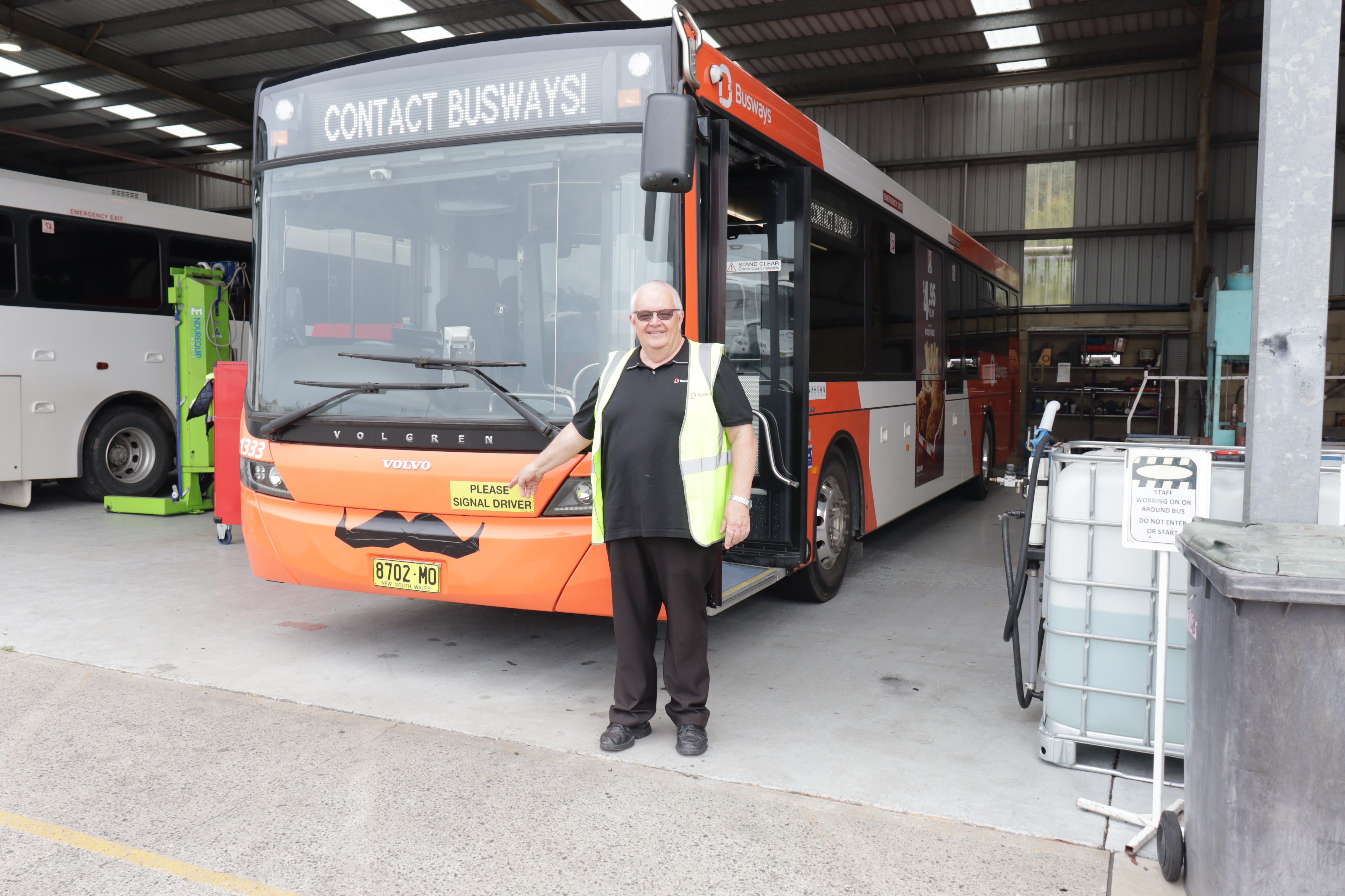 Wayne Humphries points at Moustache on bus