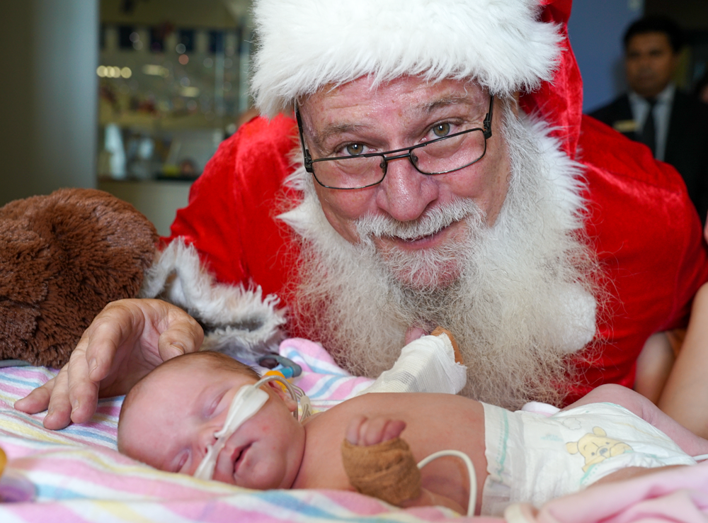 Santa visiting an unwell baby in hospital